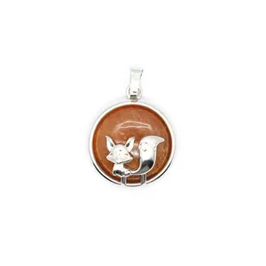 Detailed macro view of an orange lava stone pendant featuring a silver fox design motif