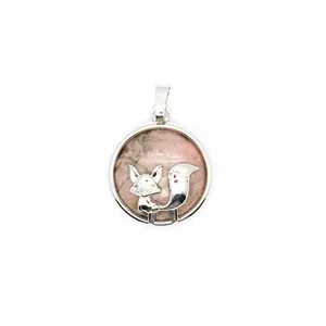 Detailed macro view of a silver fox pendant set on pink marbled natural volcanic stone