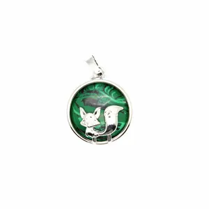 Detailed close-up showing a silver fox pendant with green marbled stone texture background.