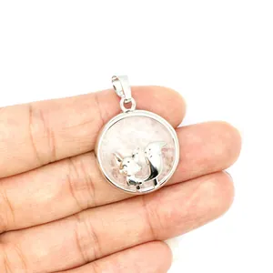 Detailed macro shot of a silver-tone fox pendant necklace featuring a pink volcanic stone