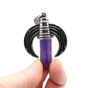 Detailed close-up of a purple amethyst hexagonal crystal pendant with silver crescent moon wings