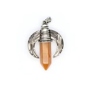 Macro view of a hexagonal orange stone crystal pendant with antique silver wings