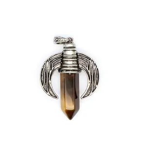 Detailed view of vintage silver dragon wing pendant with tiger eye hexagonal crystal