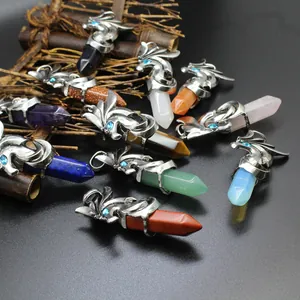 Detailed view of dragon wrap hexagonal crystal point pendants in various natural stones