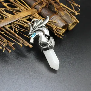Detailed view of silver flying dragon pendant wrapped around white hexagonal crystal.