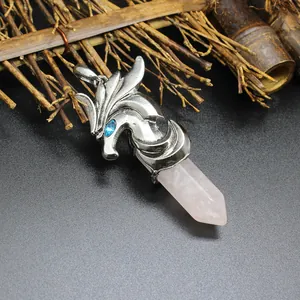 Detailed macro view of men's dragon necklace pendant with pink hexagonal crystal point