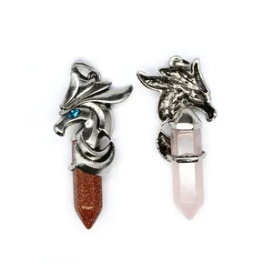 Detailed view of dragon head hexagonal crystal pendants with rose quartz and goldstone