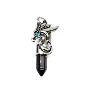 Detailed view of silver dragon pendant wrapping around black hexagonal crystal column.