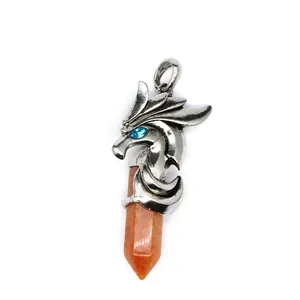 Detailed macro view of a silver-toned dragon head pendant with an orange sunstone column
