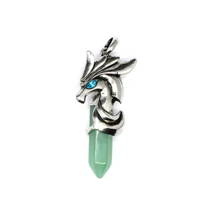 Detailed close-up of a vintage silver dragon pendant with a green hexagonal crystal stone.