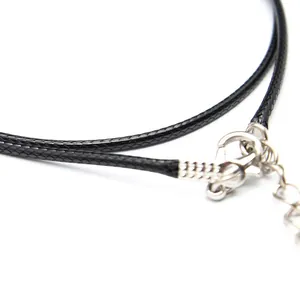 Macro view of a 2mm black leather cord necklace with silver lobster clasp and extender.
