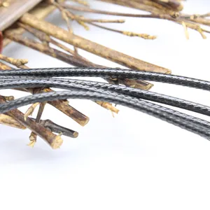 Macro detail of a 2mm black braided leather cord necklace with fine texture.