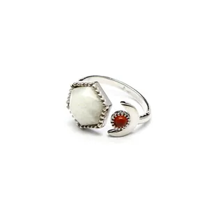 Detail of silver open ring with hexagonal white stone and crescent moon stone