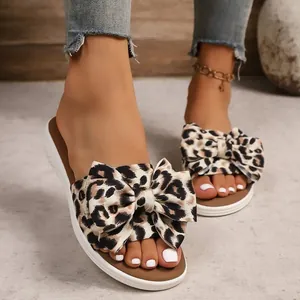 Close-up of stylish leopard print bow flat slides for women with soft casual sole