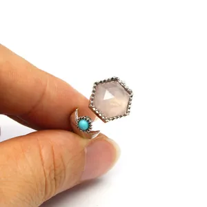 Close-up detail showing the hexagon crystal and turquoise bead on an open ring