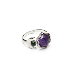 Detailed view of bohemian silver open ring with purple hex crystal and green moon stone