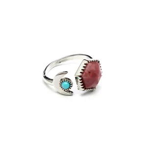 Macro view showing detail of hexagonal red stone and turquoise moon on adjustable ring
