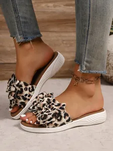 Close-up detail of leopard print bow-knot flat sandals with comfortable soft white soles