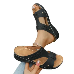 Comfortable black wedge sandals for women with stylish laser-cut patterns for summer.