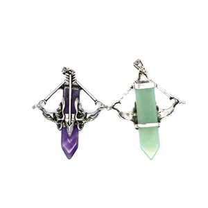 Detail view of Cupid's bow and arrow pendants with purple and green crystal points.