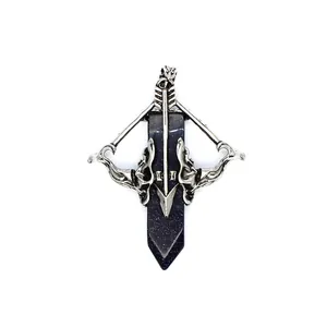 Macro view of Cupid's bow and arrow crystal pendant with blue goldstone pillar