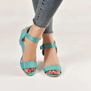 Close-up of women's teal blue wedge sandals with adjustable ankle strap buckle