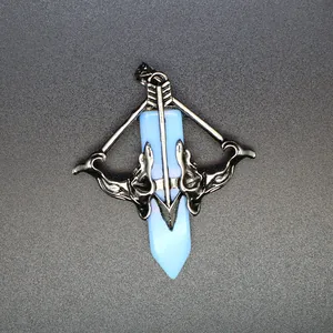 Detailed macro view of Cupid's bow and arrow pendant with a light blue crystal point