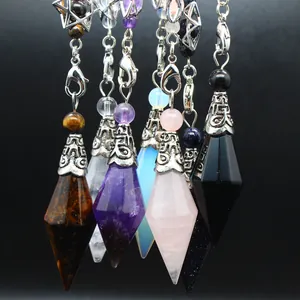Detailed view of assorted natural stone dowsing pendulums with hexagonal crystal points.