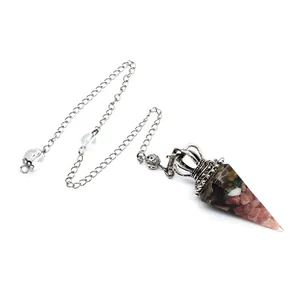 Detail of crystal resin pendulum with crushed stones and crown-shaped metal chain link