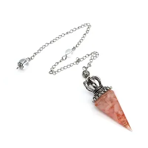 Close-up of pink crystal resin dowsing pendulum with silver crown and chain detail