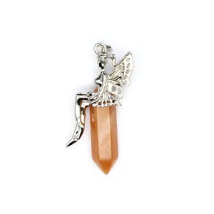 Detailed macro view of a silver fairy sitting on an orange hexagonal crystal stone pendant