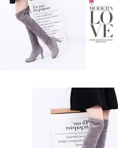 Detail view of grey suede over-the-knee boots with chunky high heels