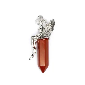 Macro detail showing a silver fairy sitting on top of a red jasper hexagonal crystal pendant