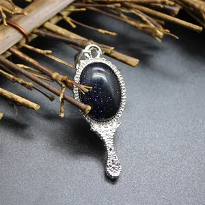 Detailed view of blue goldstone magic mirror pendant with vintage silver handle