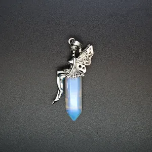 Macro view of silver fairy figurine sitting on a translucent hexagonal opalite crystal