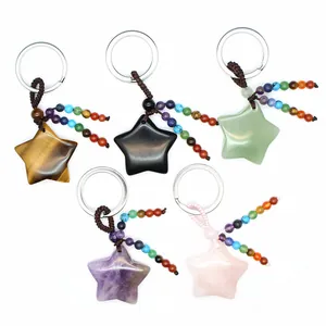Five colorful natural crystal star keychains featuring chakra bead tassel charms