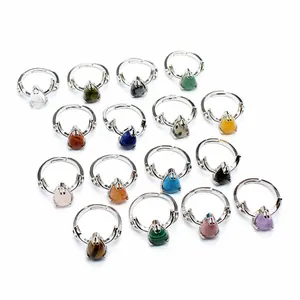 Detailed view of teardrop natural stone rings with silver antler design in various colors