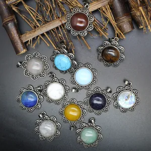Detailed view of bohemian antique silver flower pendants with colorful natural stones