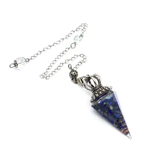 Detail view of a resin dowsing pendulum with blue crystal chips and silver crown cap