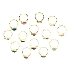 Variety of gold open rings with hexagonal natural stones shown in a flat lay
