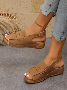 Women's tan wedge sandals with platform sole and adjustable ankle strap detail