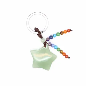 Detail of natural green aventurine star keychain with colorful chakra beads.