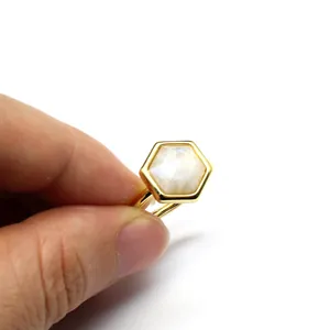 Detailed view of a hexagonal natural crystal stone set in a gold-plated open ring band