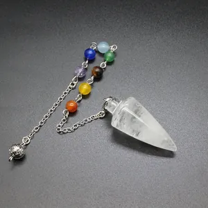 Close-up of a clear crystal cone dowsing pendulum with seven colored chakra beads.