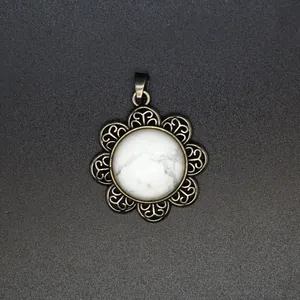 Detail of natural white stone pendant with vintage antique silver filigree flower base