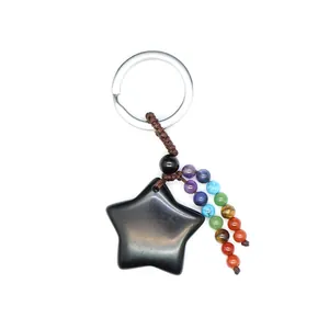 Detailed macro view of a natural black obsidian star keychain with colorful chakra beads