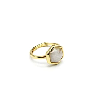 Close-up of a gold adjustable ring featuring a hexagonal natural sunstone crystal.