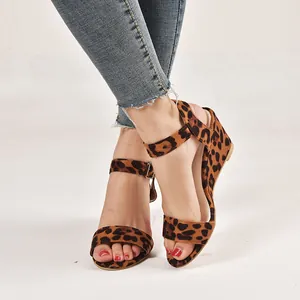 Close-up of leopard print wedge sandals with buckle ankle strap for women