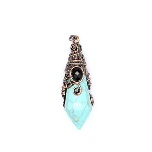 Detailed view of a turquoise crystal pendant wrapped in antique copper wire with black stone