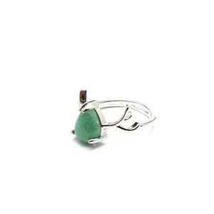 Detail shot of silver antler ring with green teardrop-shaped natural stone gemstone